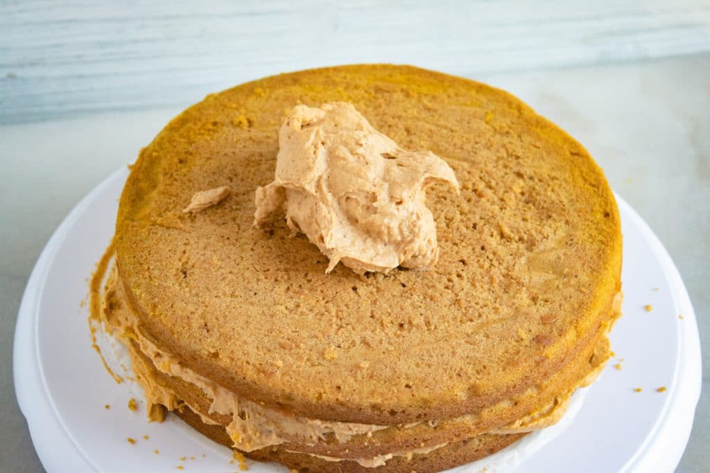 dollop of pumpkin ganache on a pumpkin cake