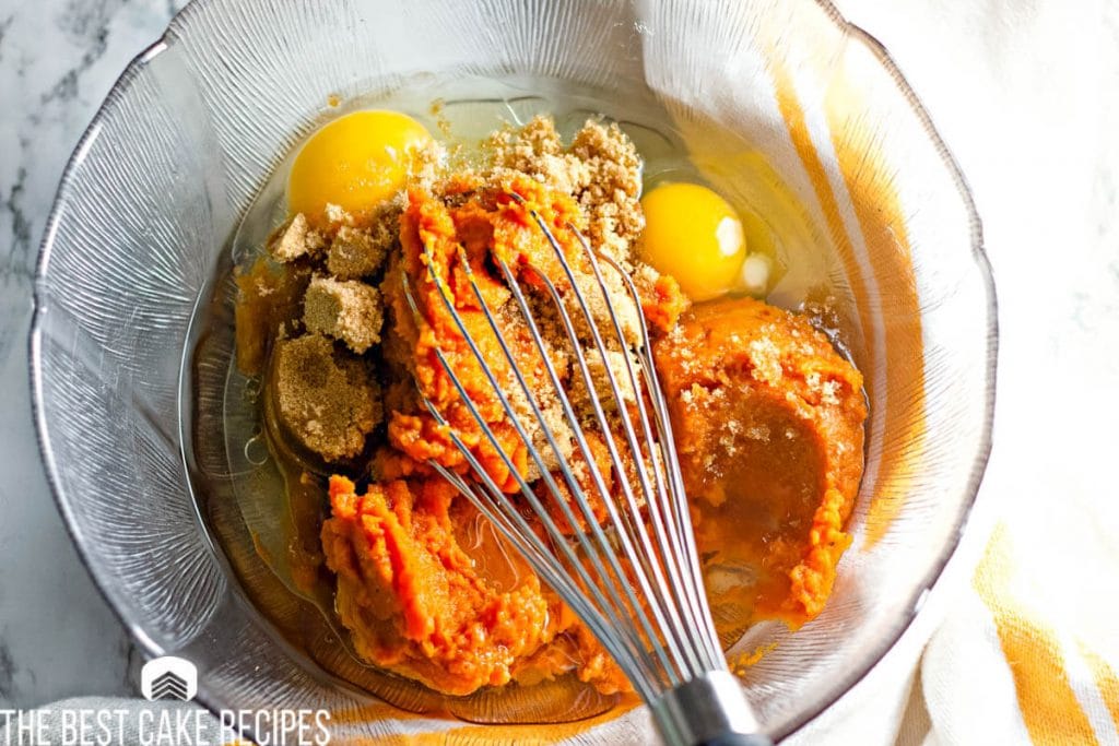 unmixed pumpkin batter in bowl with a whisk