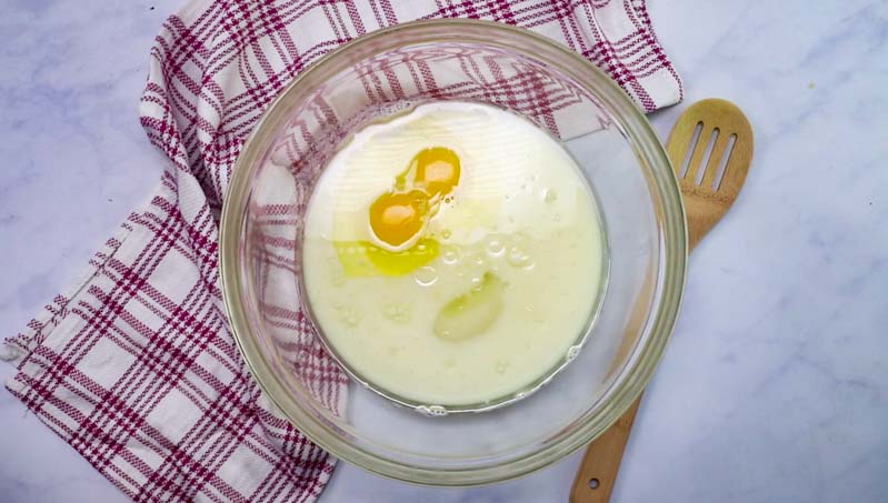 eggs milk and oil in a bowl