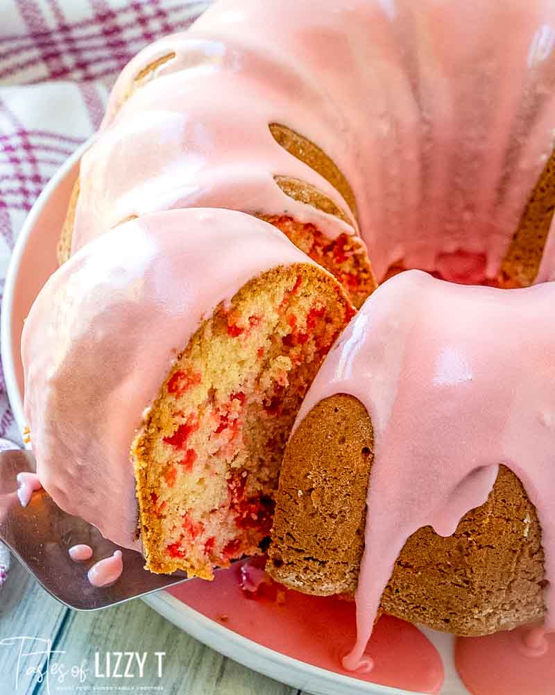 glazed Cherry Bundt Cake with a slice on a spatula