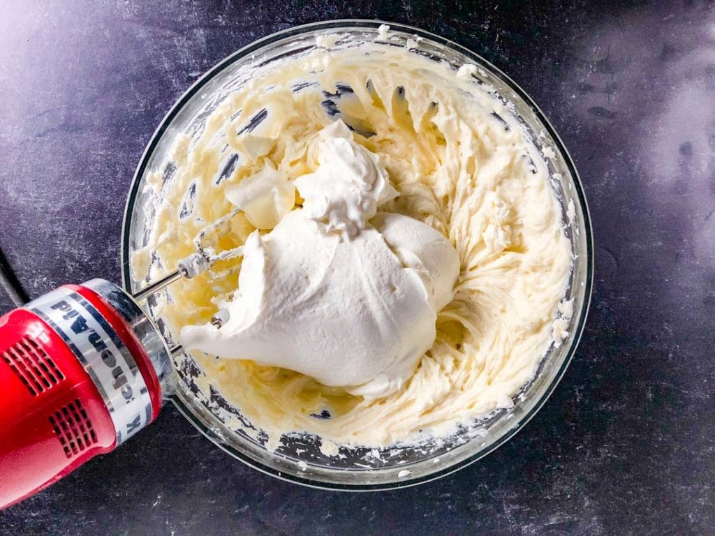 mixing sour cream into cheesecake batter