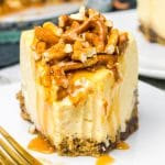 Caramel Pretzel Cheesecake on a plate with a bite out