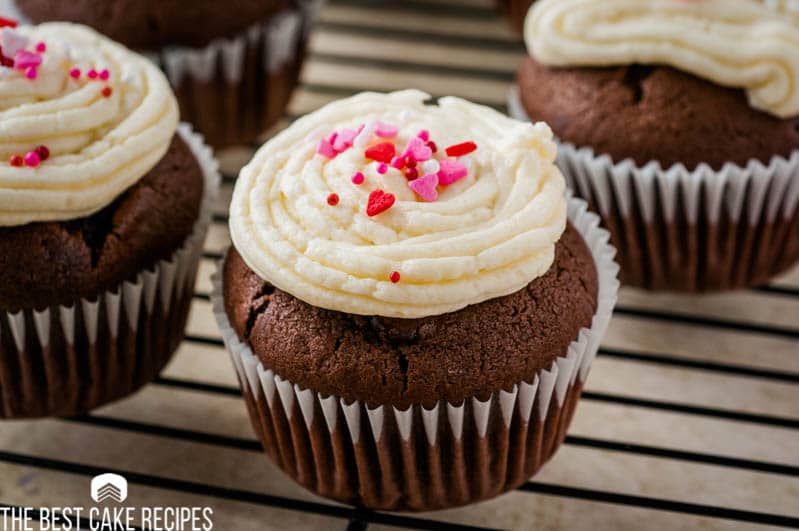 A close up of a chocolate cupcake with frosting