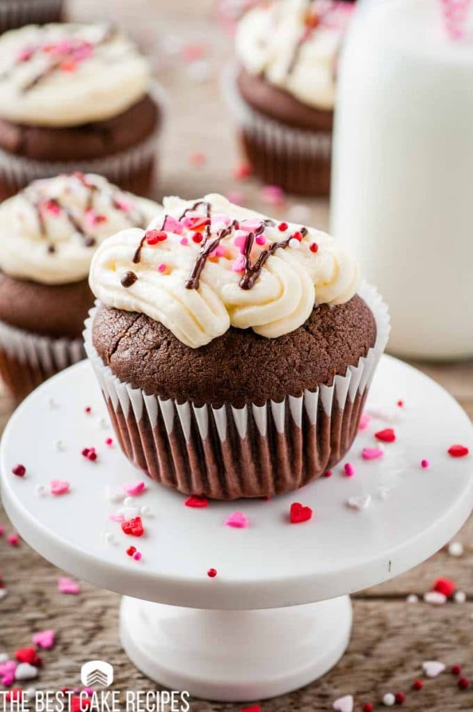 A close up of a plate of birthday cupcake on a table