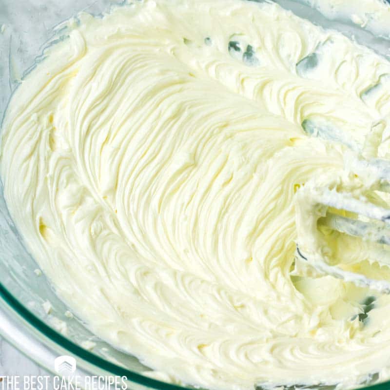creaming cream cheese in a mixing bowl