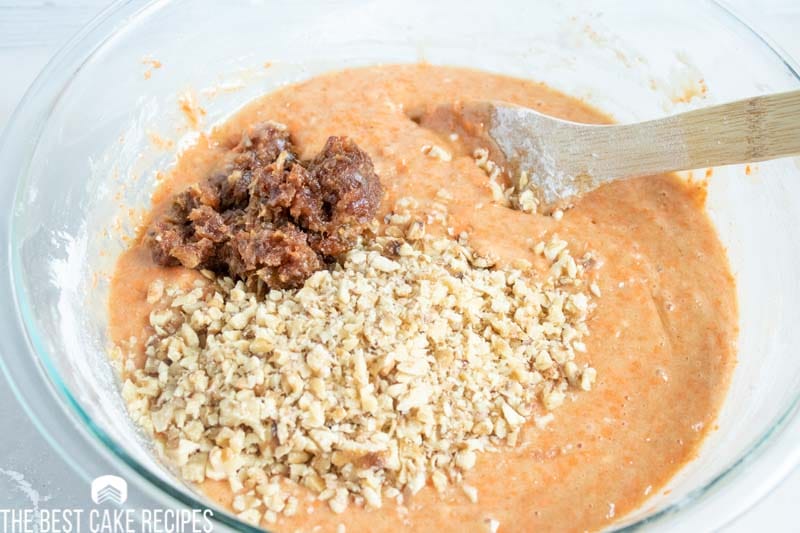 carrot cake batter in bowl with nuts 