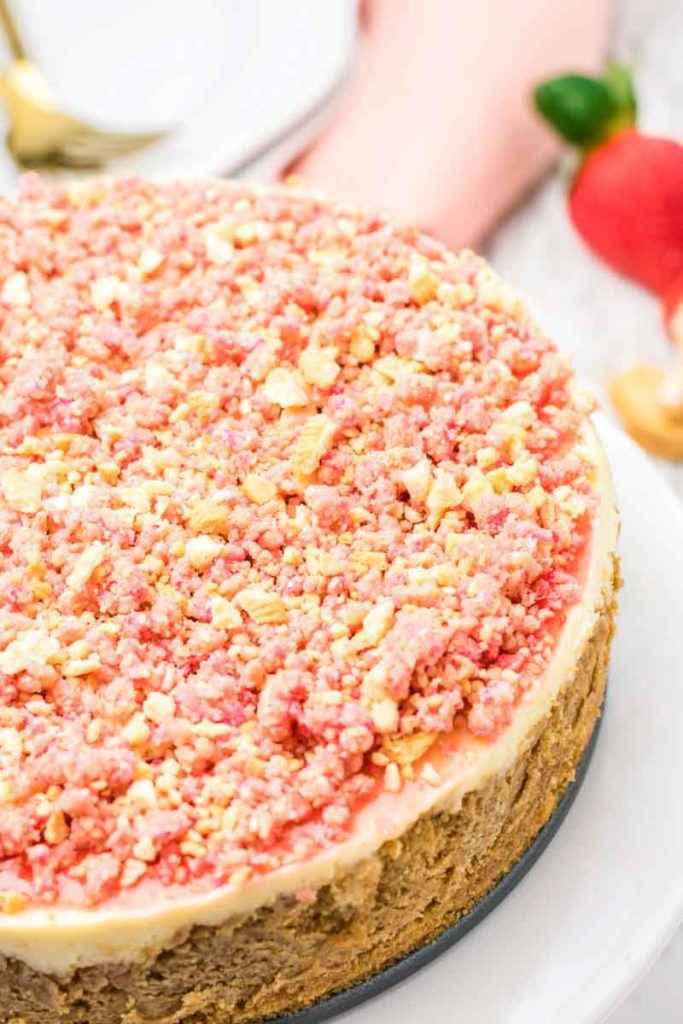 A close up of strawberry crunch cheesecake