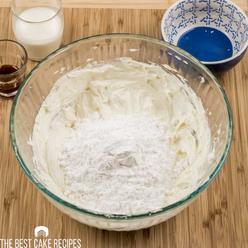 cream cheese and butter in bowl with powdered sugar