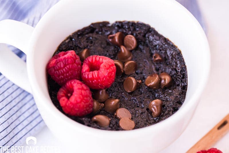 chocolate mug cake with chocolate chips and raspberries