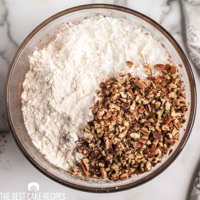 mixing bowl with coconut, flour and walnuts