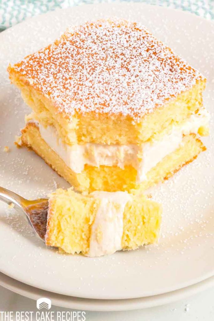 two layer yellow cake with cream filling on a plate 