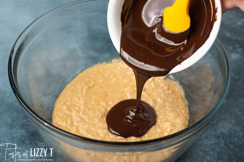 pouring melted chocolate in cake batter