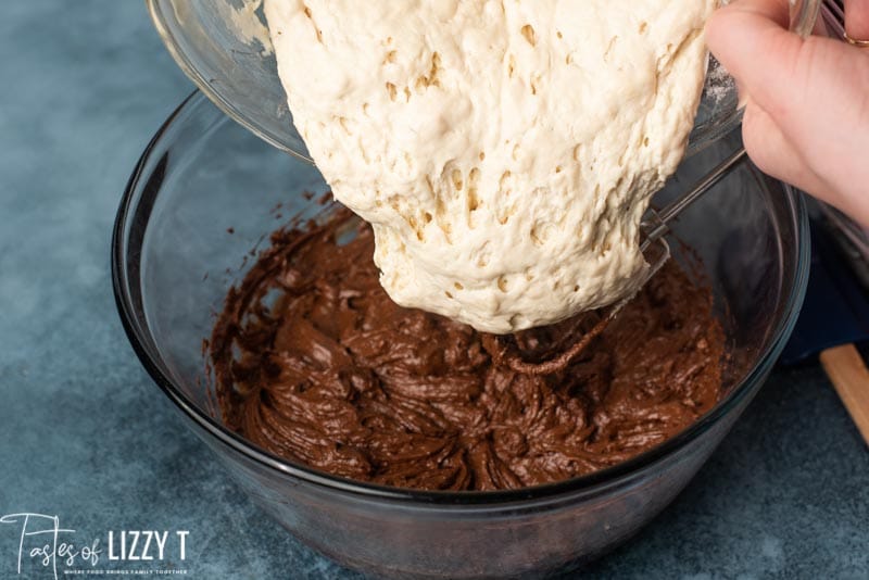 pouring sourdough in chocolate cake mix