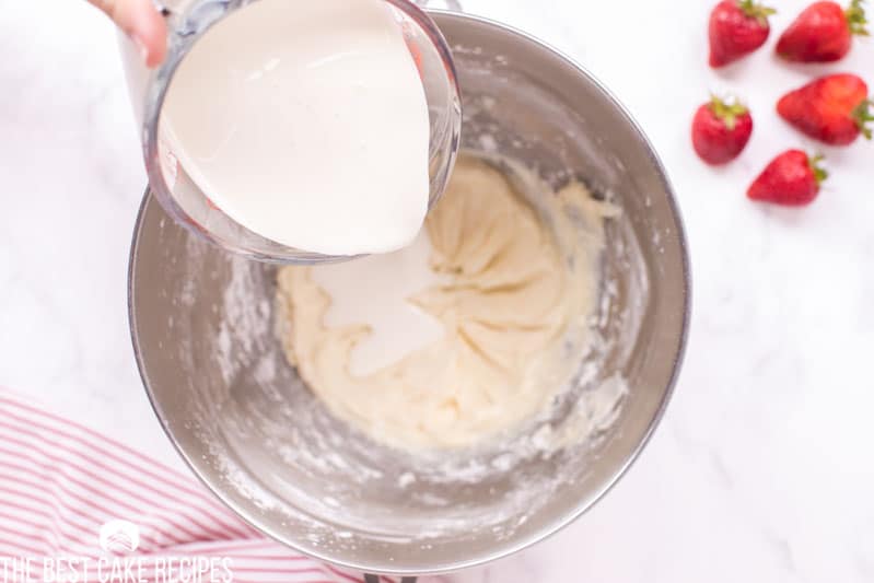 heavy cream pouring into a measuring bowl