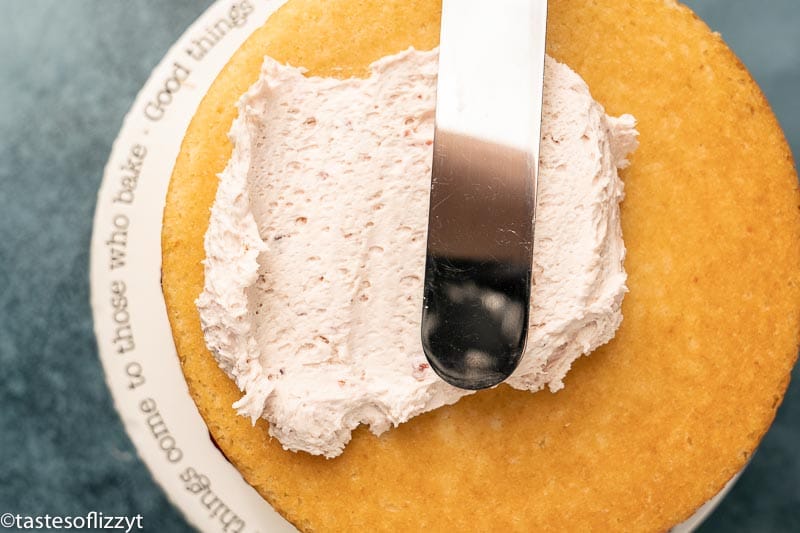 spatula spreading frosting on a cake