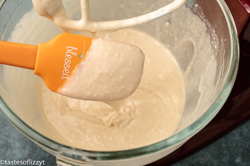 cake batter in a mixing bowl with spatula