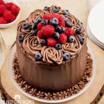 raspberries and blueberries on a chocolate cake