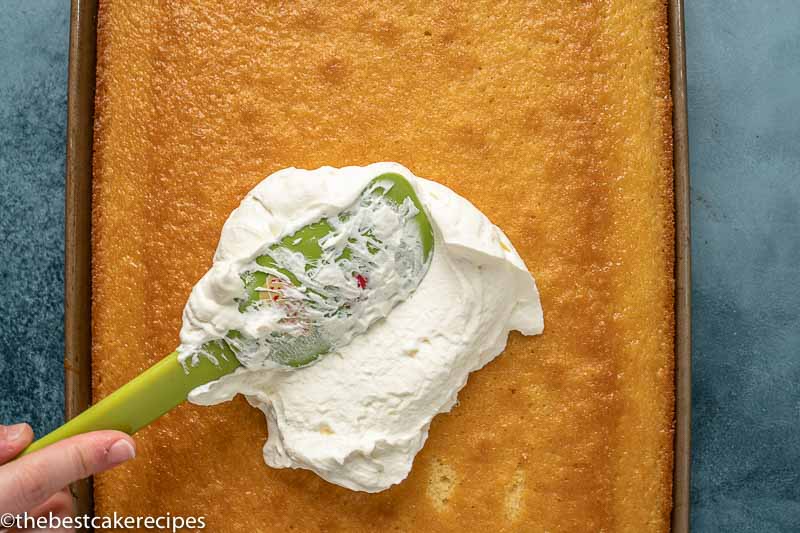 spreading mascarpone cream on a cake