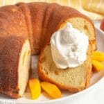 slice of peach cake with whipped cream
