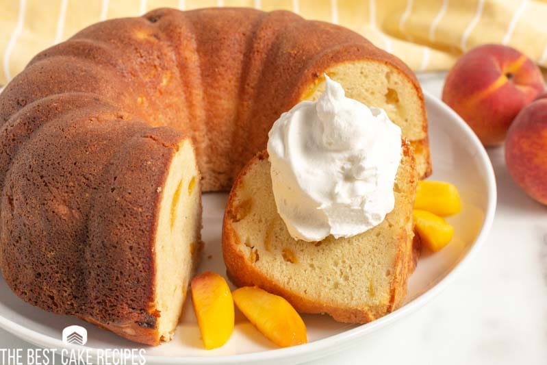 slice of peach cake with whipped cream
