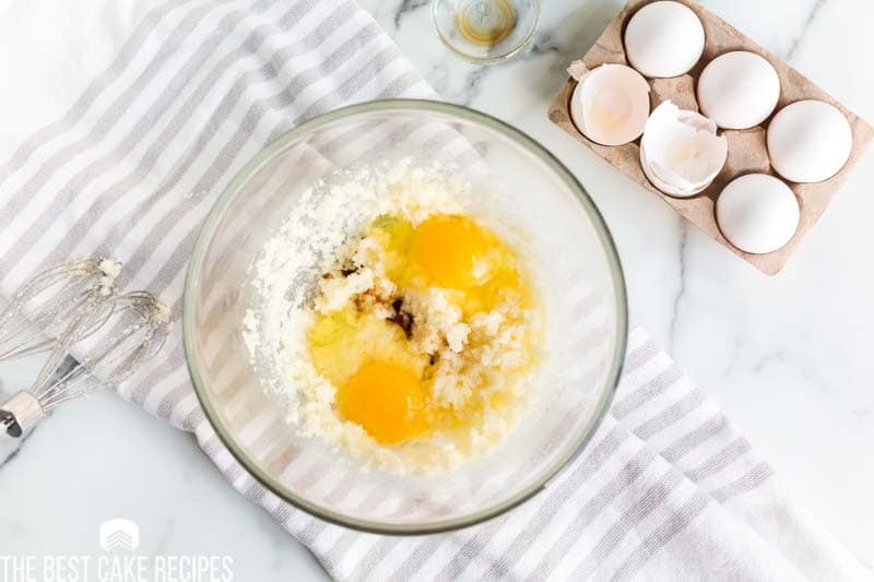 eggs in a mixing bowl with creamed butter and sugar