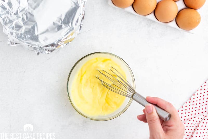 whisking eggs in a small bowl