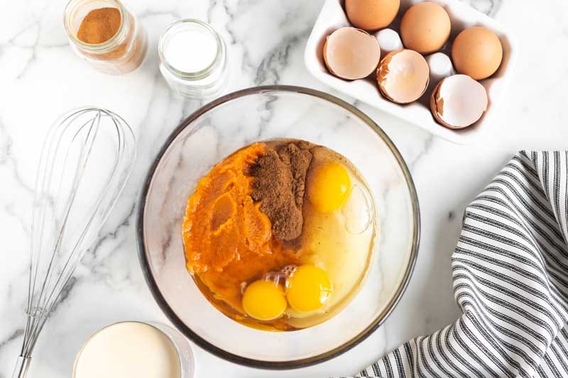 pumpkin, spices and eggs in a mixing bowl