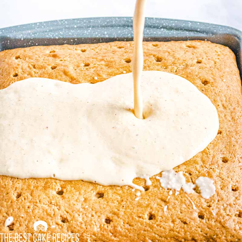 pouring eggnog over poke cake