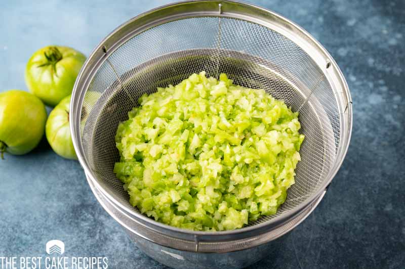 grated green tomatoes in a colander