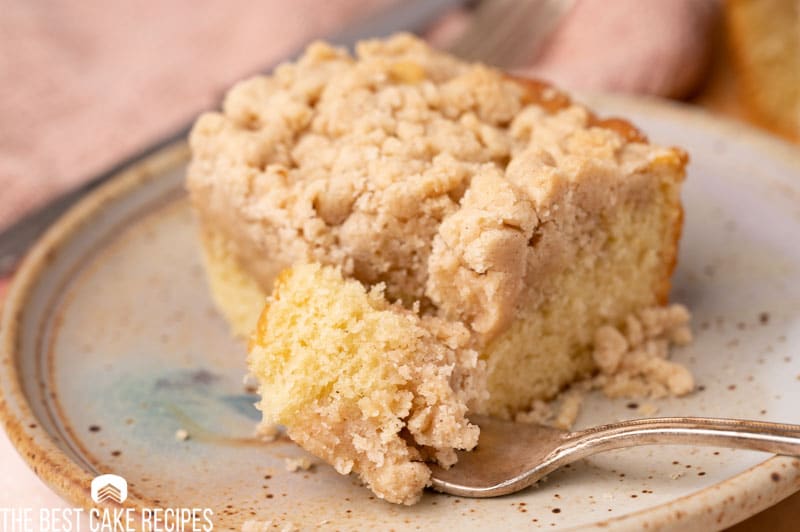 new york crumb cake on a plate with a fork