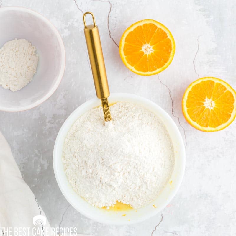 flour on top of wet ingredients in a bowl