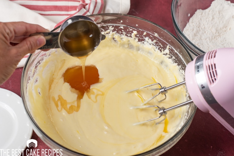 pouring honey into cake batter