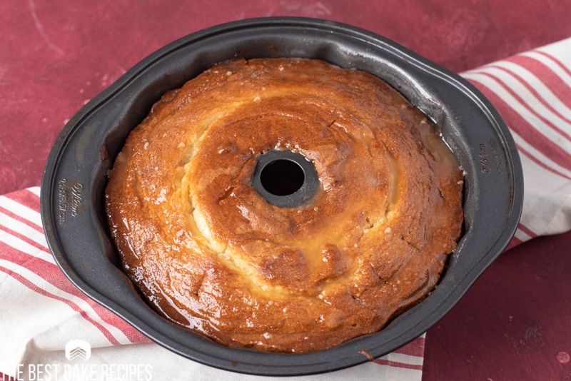 pound cake in pan with glaze