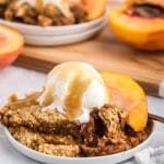 slow cooker peaches and cream cake a la mode on a plate