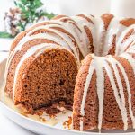 gingerbread bundt cake on a plate with one slice out