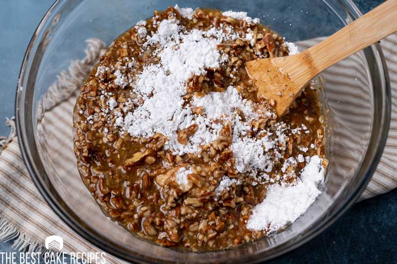 mixing pecan praline frosting with powdered sugar