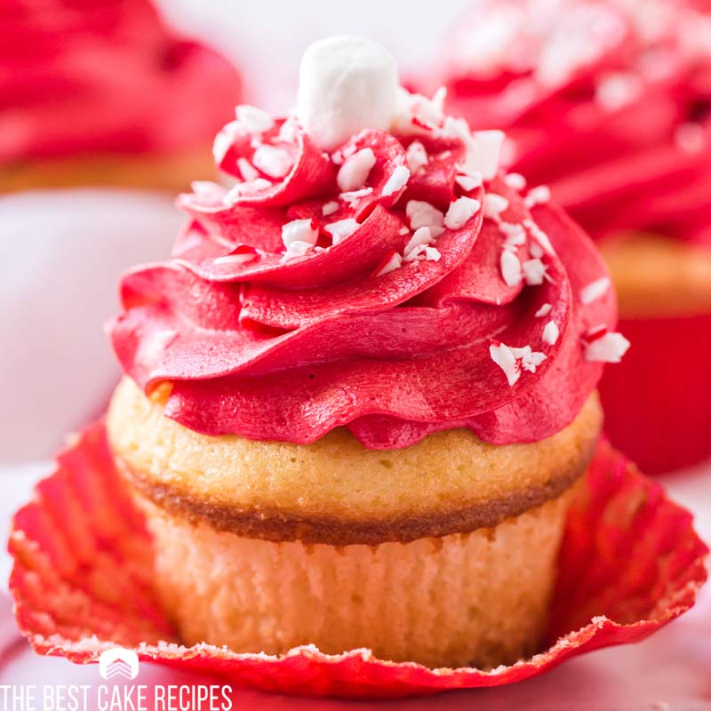 closeup of unwrapped cupcake with red frosting