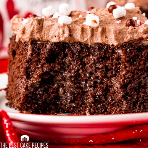 close up of a piece of peppermint hot chocolate poke cake