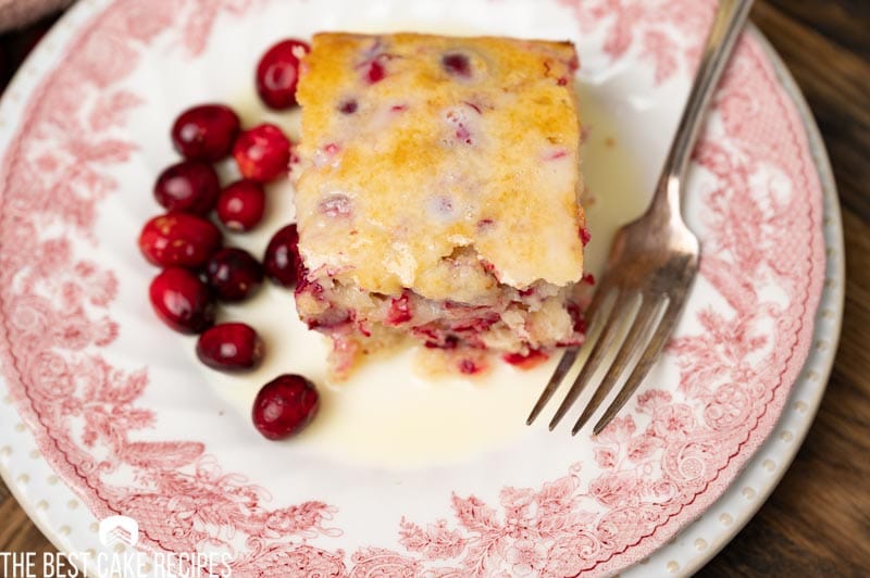 overhead view of a piece of cranberry cake with butter sauce