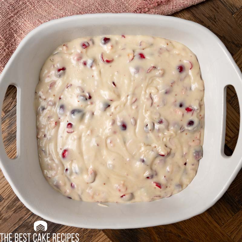 unbaked cranberry cake in a baking pan