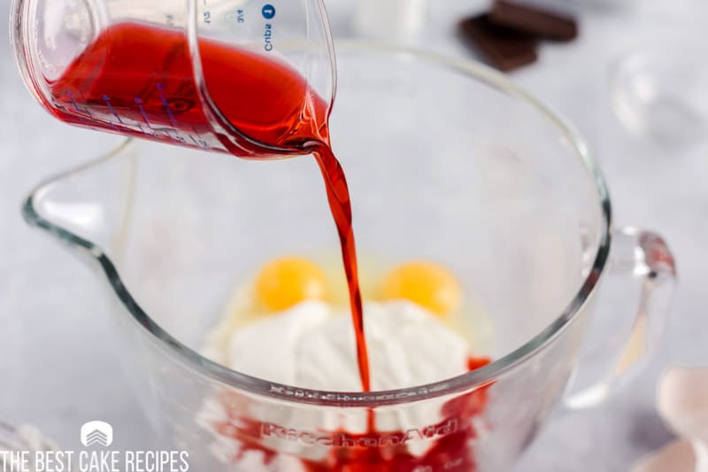 cherry juice pouring into a mixing bowl