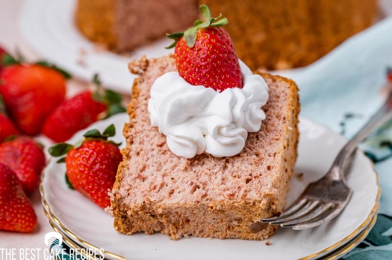 cake sitting on a plate with a strawberry