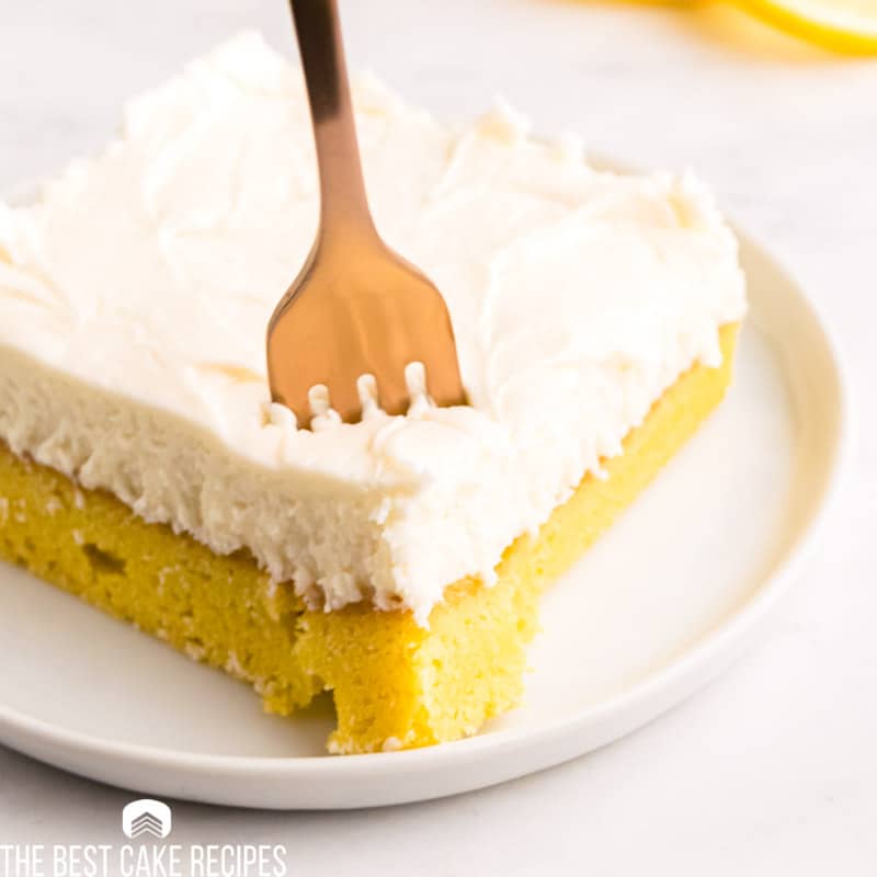 closeup of a frosted lemon brownie with a fork