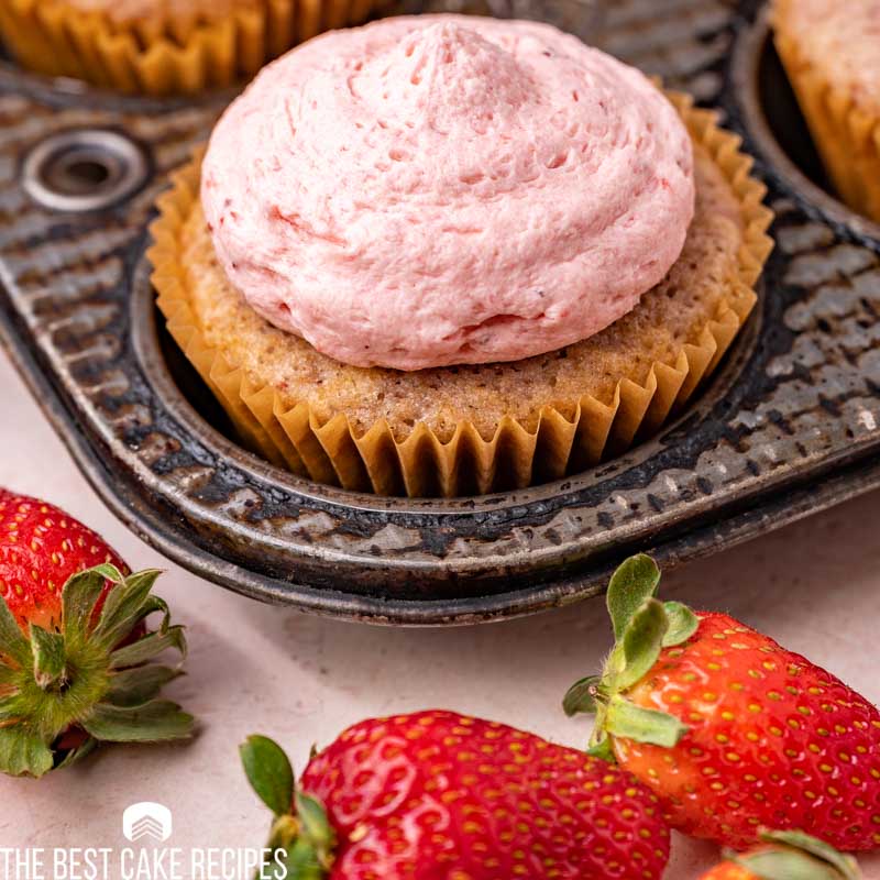 a strawberry cupcake in a muffin pan
