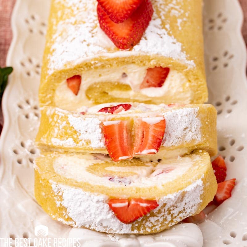 sliced strawberry cake roll on a plate