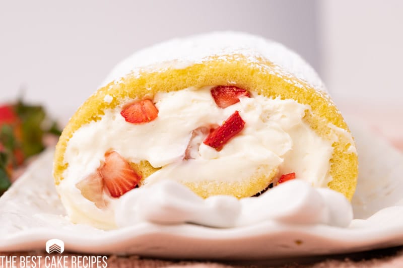 a stuffed cake roll with cream cheese filling and strawberries