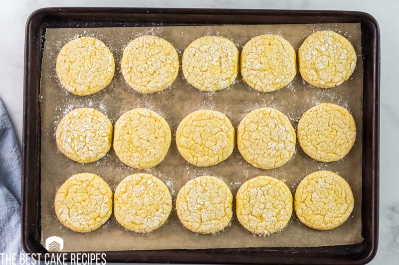 lemon cookies on a parchment paper lined baking sheet