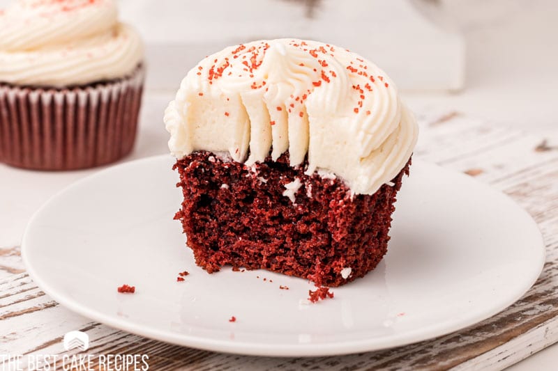 half of a red velvet cupcake on a plate