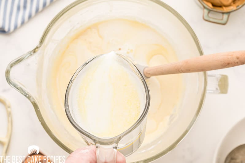 pouring milk and butter into a mixing bowl