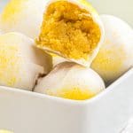 a pile of lemon cake balls with one broken open